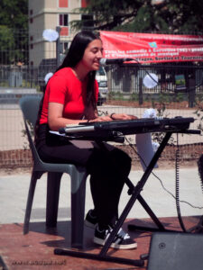 Naomi, au piano, commence seule, et chante tout en s'accompagnant, sur le titre "Sarcelles"